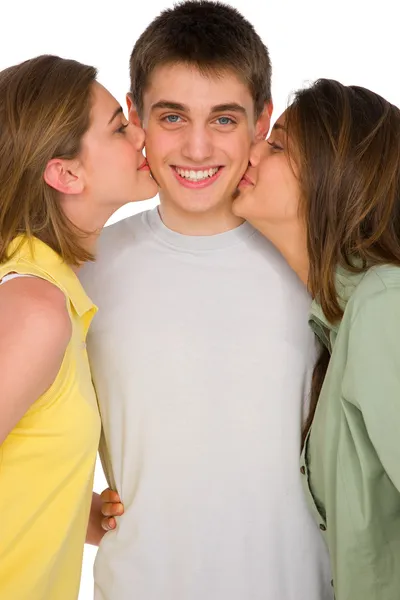 Teenage girls kissing teenage boy — Stock Photo, Image