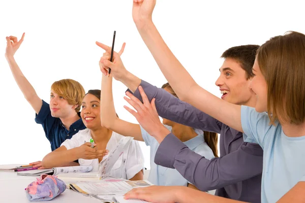 Teenagers in classroom with arms up — Stock Photo, Image