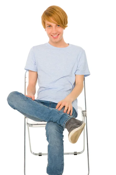 Teenage boy sitting on chair — Stock Photo, Image