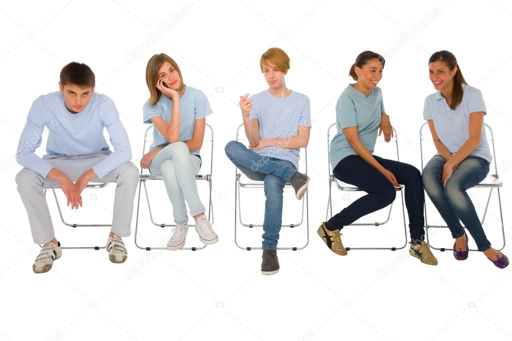 Teenagers sitting on chairs