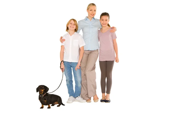 Mother son daughter standing and smiling with small dog — Stock Photo, Image