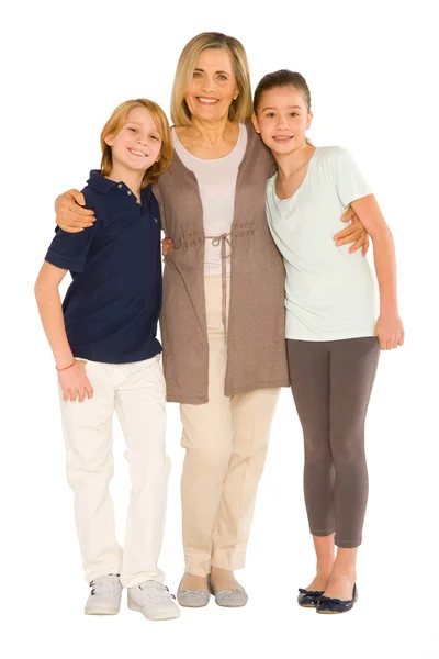 Young grandmother with nephew and niece standing on white backgr — Stock Photo, Image