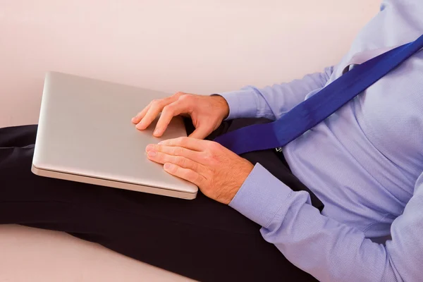 Podnikatel s notebookem sedět gauč — Stock fotografie