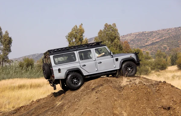 Silver Land Rover Defender 110 SW on 4x4 Course — Stock Photo, Image