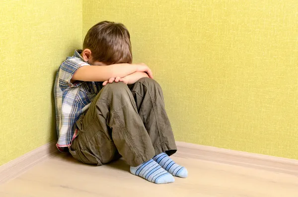 Little child boy wall corner punishment sitting — Stock Photo, Image