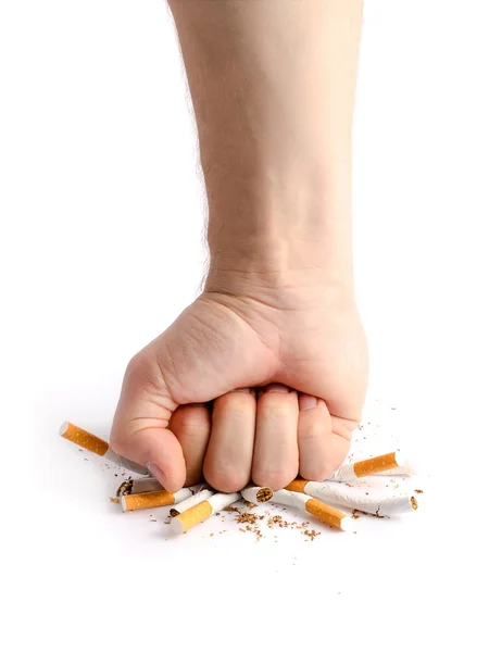Man's fist crushing cigarettes — Stock Photo, Image