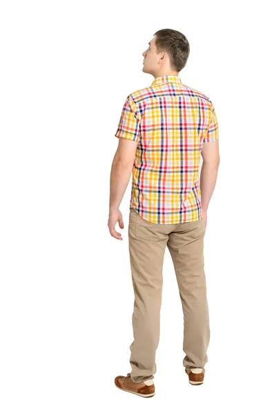 Vista posterior de un hombre joven en una camisa a cuadros y vaqueros buscando — Foto de Stock