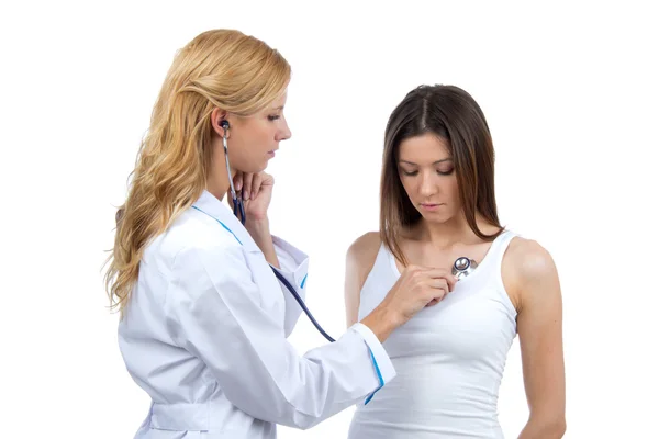 Doctor woman auscultating young patient by stethoscope — 스톡 사진