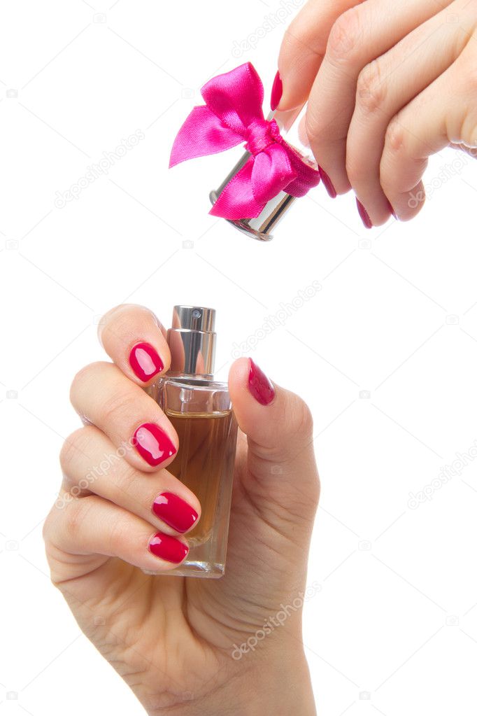 Woman hand spraying perfume