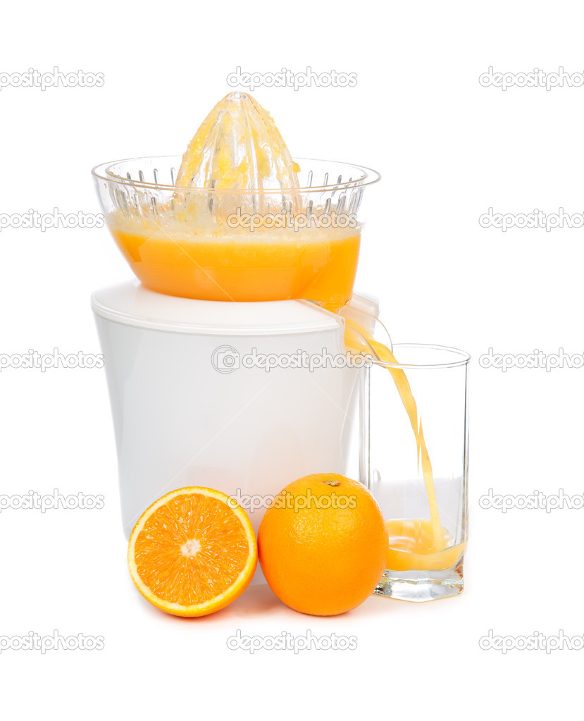Preparing fresh orange juice squeezed with electric juicer
