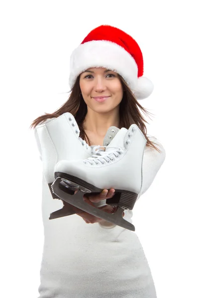 Woman showing ice skates in christmas santa hat smiling — Stock Photo, Image
