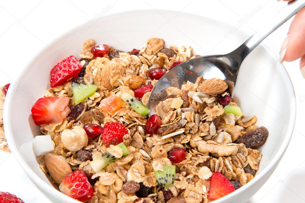 Muesli cereals bowl and spoon with almond, pine nuts