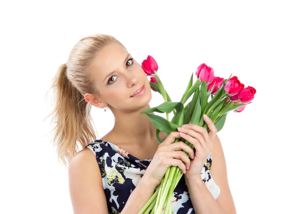 Young pretty woman holding a bunch of red tulips bouquet — Stock Photo, Image