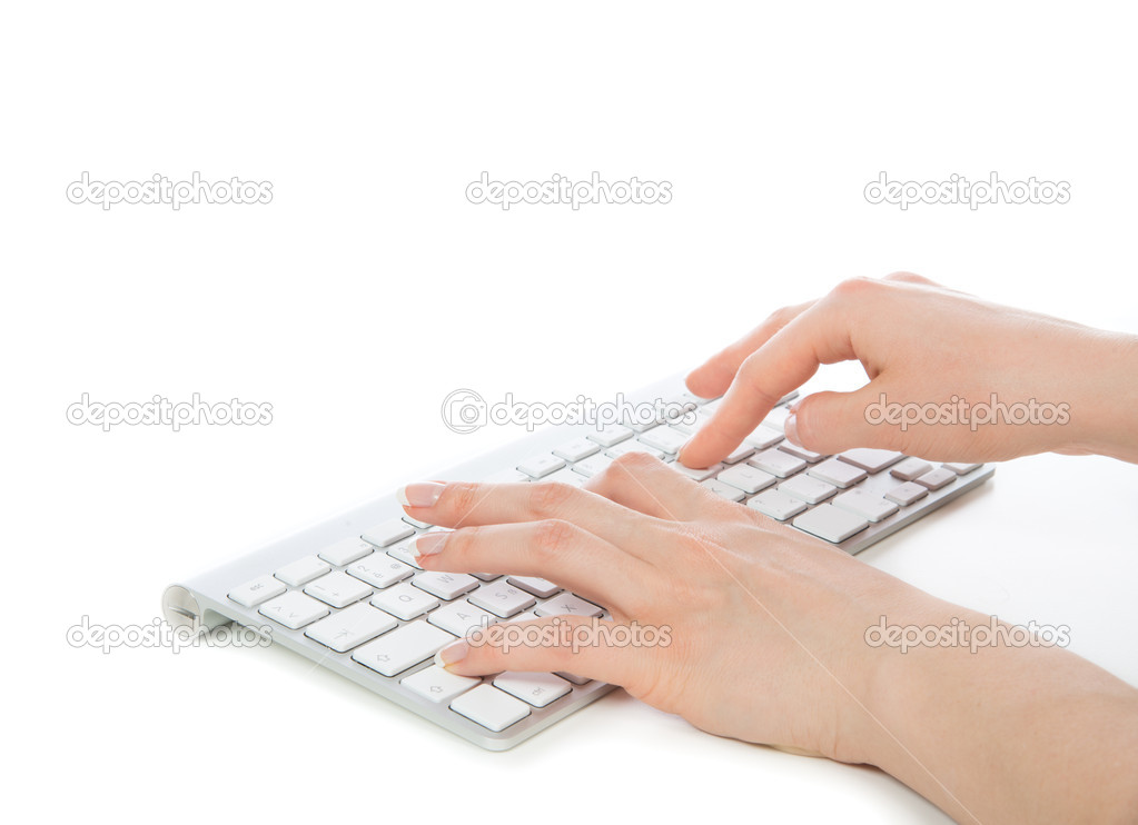 Hands typing on the remote wireless computer keyboard