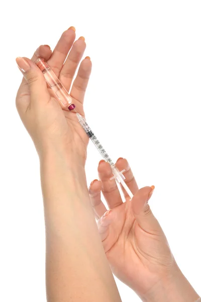 Doctor hands with medical syringe with needle in ampule — Stock Photo, Image