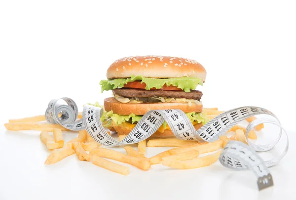 Burger cheeseburger meal with french fries tape measure — Stock Photo, Image