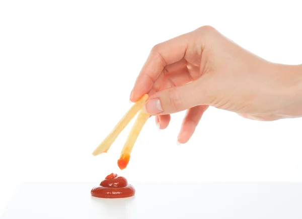 Hand dip french fries chips into ketchup — Stock Photo, Image