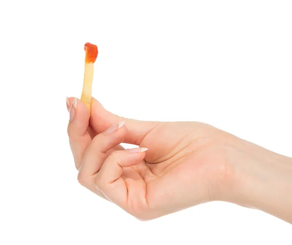 Hand with dip french fries chips into ketchup — Stock Photo, Image