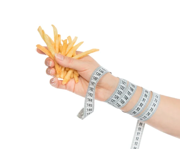 French fries chips in hand with tape measure — Stock Photo, Image