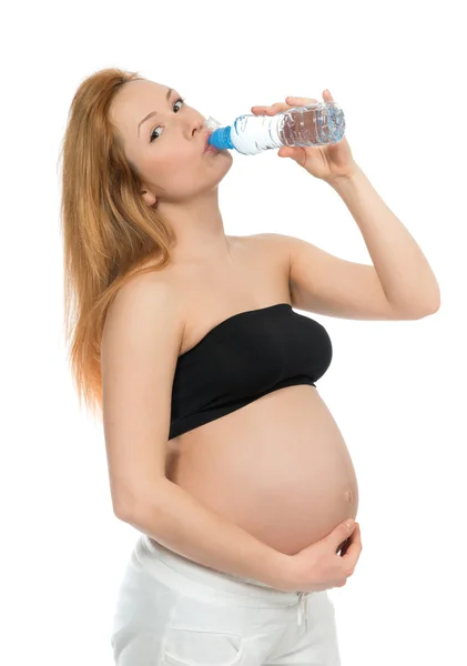 Young happy pregnant woman drinking water bottle — Stock Photo, Image