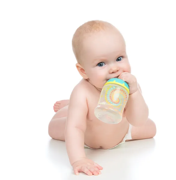 Child baby girl lying happy holding breastfeeding bottle nipple — Stock Photo, Image