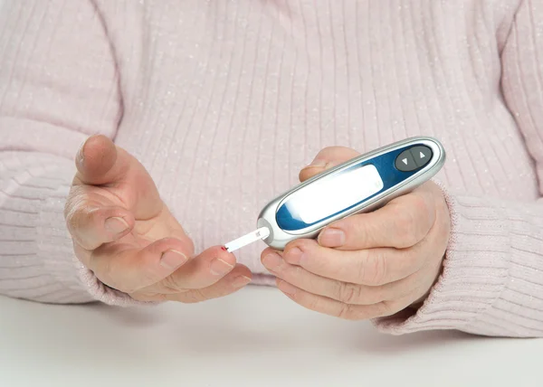 Diabetes patient senior woman measuring glucose level blood test — Stock Photo, Image