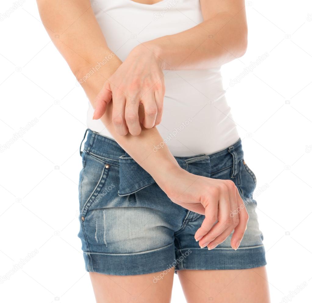 Young woman allery scratching her arm