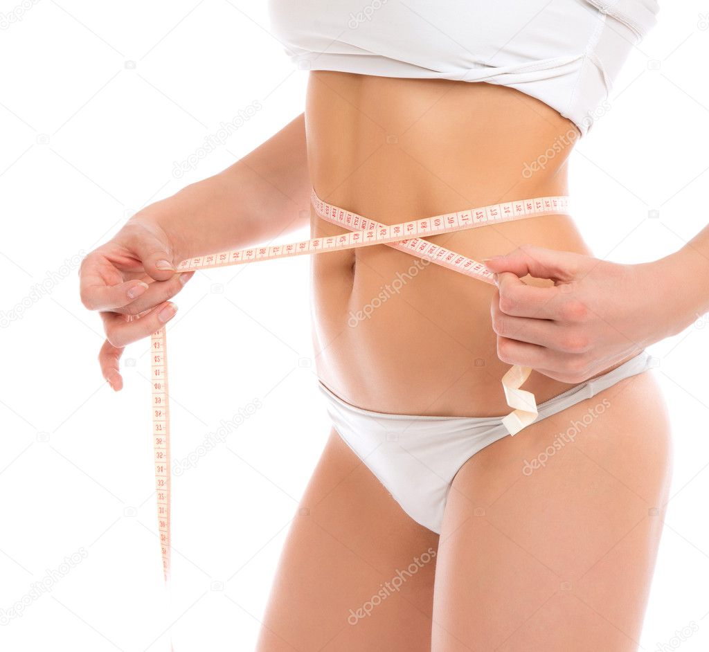 Slim woman measuring waist with tape measure