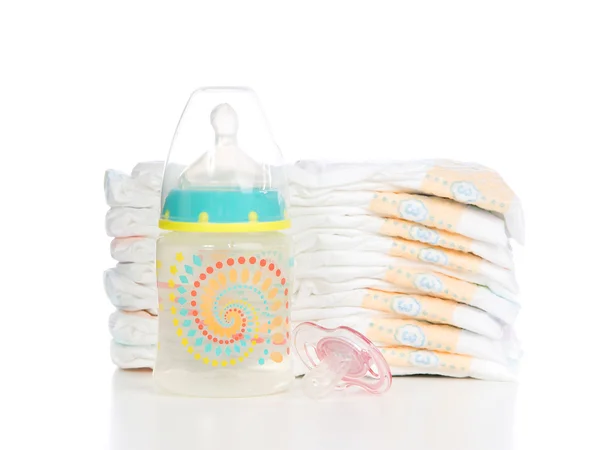 Child stack of diapers, nipple soother baby feeding bottle with — Stock Photo, Image