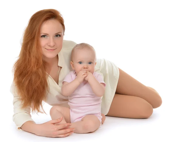 Happy family mother and child baby girl hugging lying — Stock Photo, Image