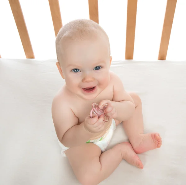 Infant child baby girl holding baby nipple soother — Stock Photo, Image