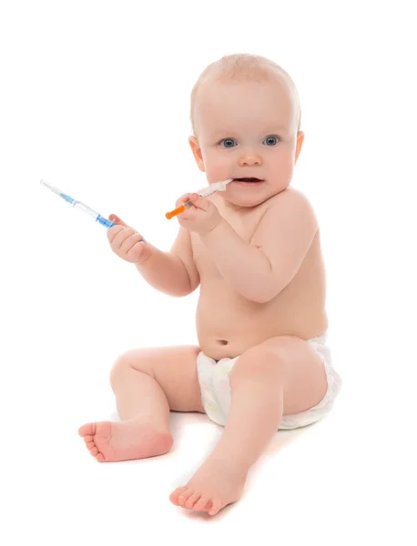 Infant child baby kid playing with medical insulin syringe in ha — Stock Photo, Image