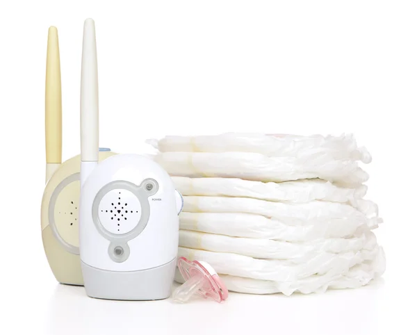 Child baby radio monitor stack of diapers nipple soother — Stock Photo, Image