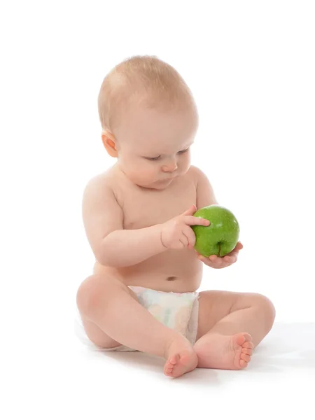 Lyckligt barn baby småbarn sitter i blöja med grönt äpple — Stockfoto