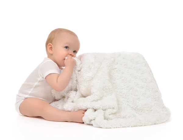 Infant child baby toddler sitting and eating soft blanket towel — Stock Photo, Image