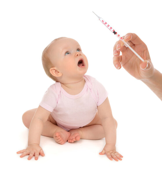 Infant child baby hand medical insulin syringe ready for injecti
