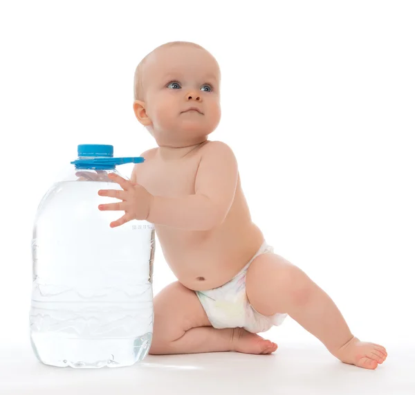 Infant child baby girl sitting with big bottle of drinking water — Stock Photo, Image
