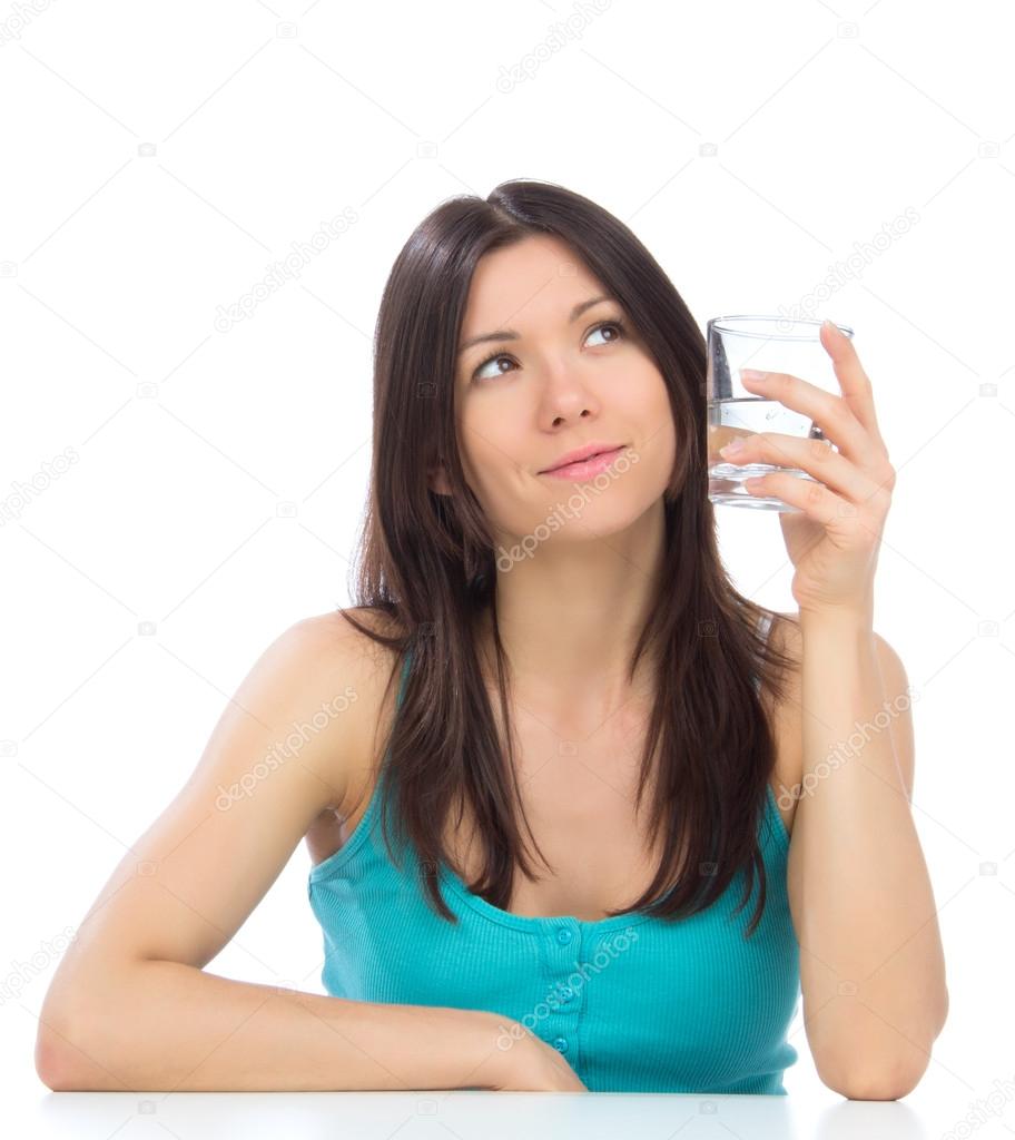 Woman getting ready to drink glass of drinking water.