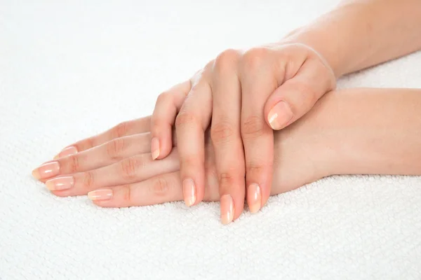 Beautiful woman hands with french manicure nails — Stock Photo, Image