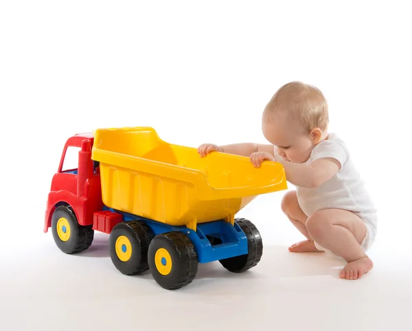 Infant child baby boy toddler big toy car truck red yellow — Stock Photo, Image