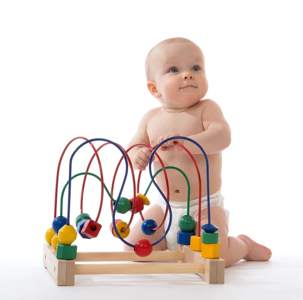 Infant child baby toddler standing and playing wooden educationa — Stock Photo, Image