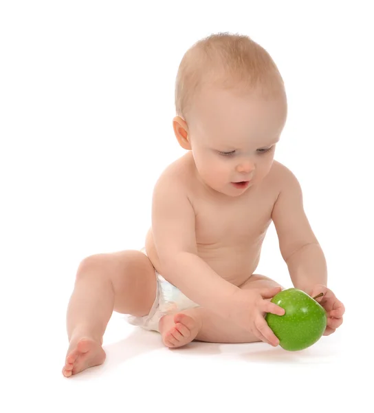 Happy child baby toddler sitting in diaper with green apple Royalty Free Stock Photos