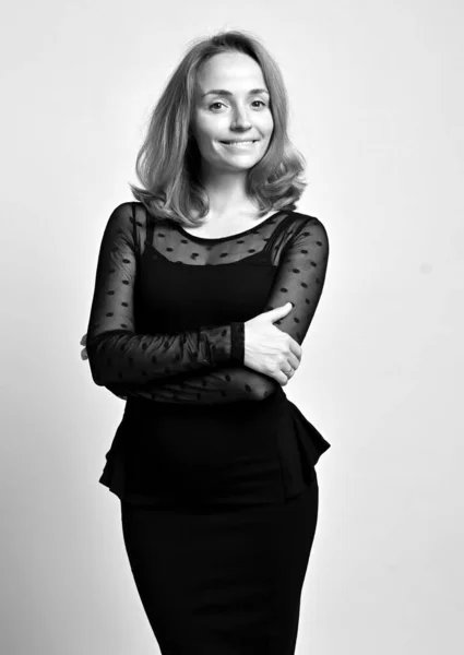 Black and white portrait of friendly slim woman office worker in black formal tight dress or lace blouse and tight skirt — Stock Photo, Image