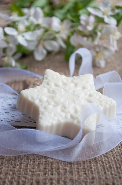 Bars of soap with flowers on sacking cloth — Stock Photo, Image