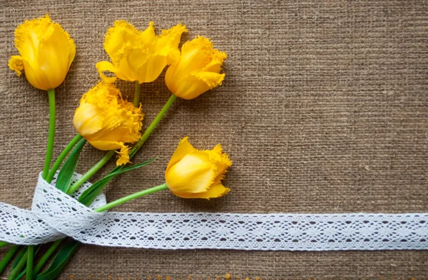Postcard with yellow flowers and handmade tape on sacking cloth — Stock Photo, Image