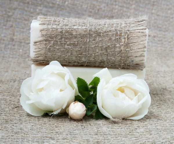 Bars of soap on vintage cloth with white roses — Stock Photo, Image