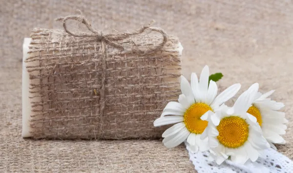 Soap on vintage natural cloth with flowers — Stock Photo, Image