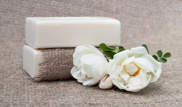 Soap on vintage natural cloth with flowers — Stock Photo, Image