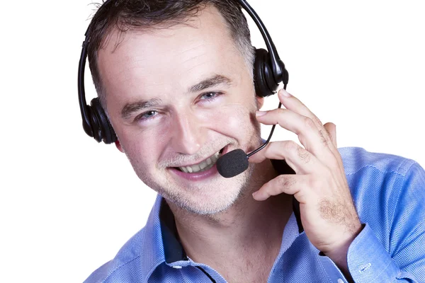 Zakenman in blauw shirt, een headset met een telefoontje. — Stockfoto