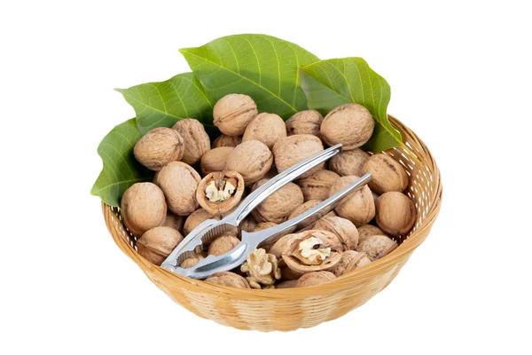 The wicker basket walnuts and nutcracker. — Stock Photo, Image